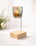 Glassybaby Candle holder with a colorful glass container and wooden base on a white background