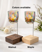 Two candle holders with wooden bases, one in walnut and one in maple, on a white background.