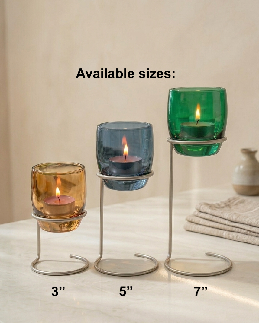 Three glass candle holders with different sizes on a neutral background