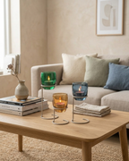 Living room with a coffee table featuring decorative candles and books.